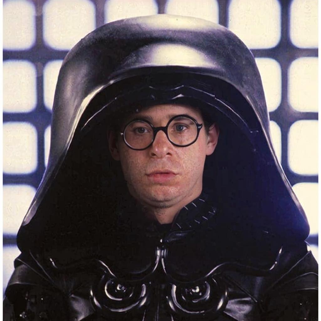 Replace the face in the helmet with the face from the second image