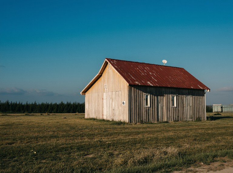 Photograph of a barn in a field