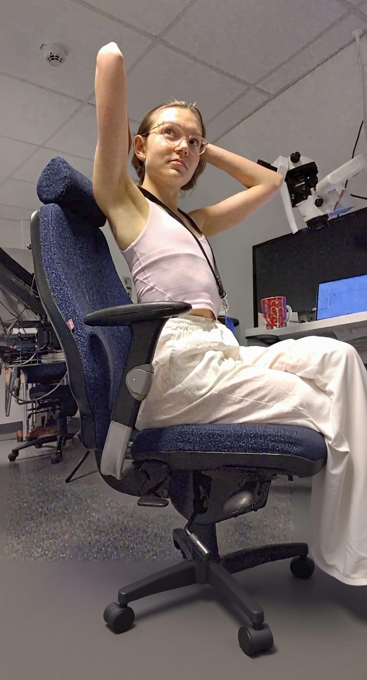 She is facing camera directly, she is facing in direction of camera with her whole body, and image captured from slightly higher angle.