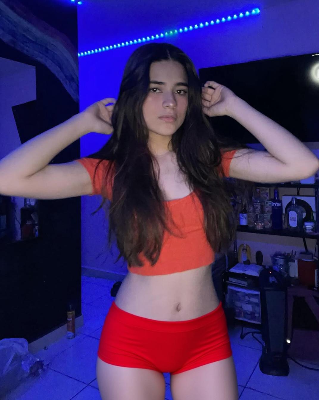Change her clothes to red underwear. Keep the same persona, the same pose, and the same lighting; just change the outfit.