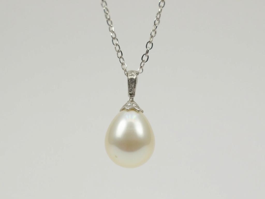a-white-pearl-and-diamond-pendant-on-a-silver-nidk3qsauo