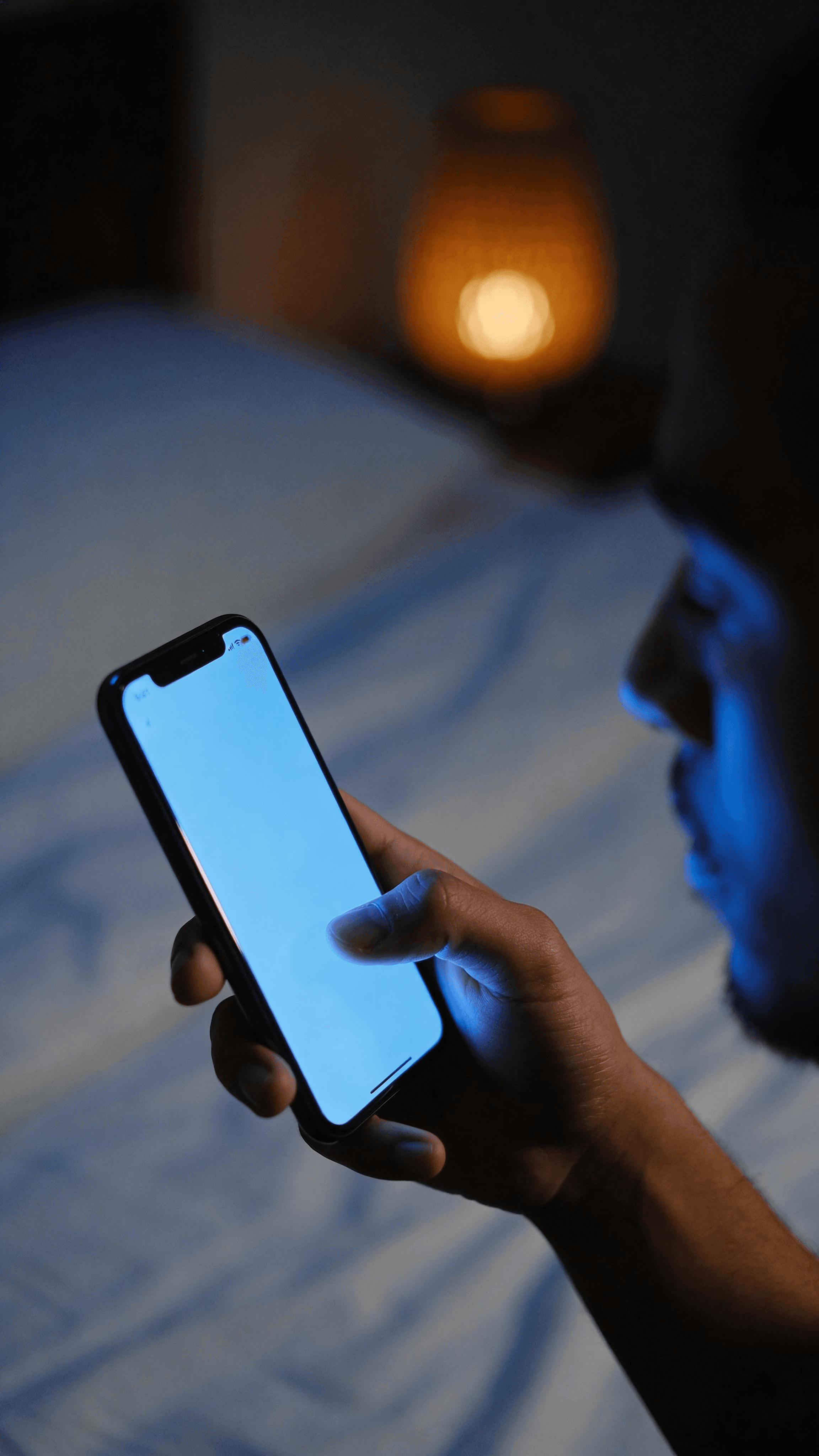 close-up-of-a-hand-holding-a-smartphone-in-a-dimly-5lrq6ggug