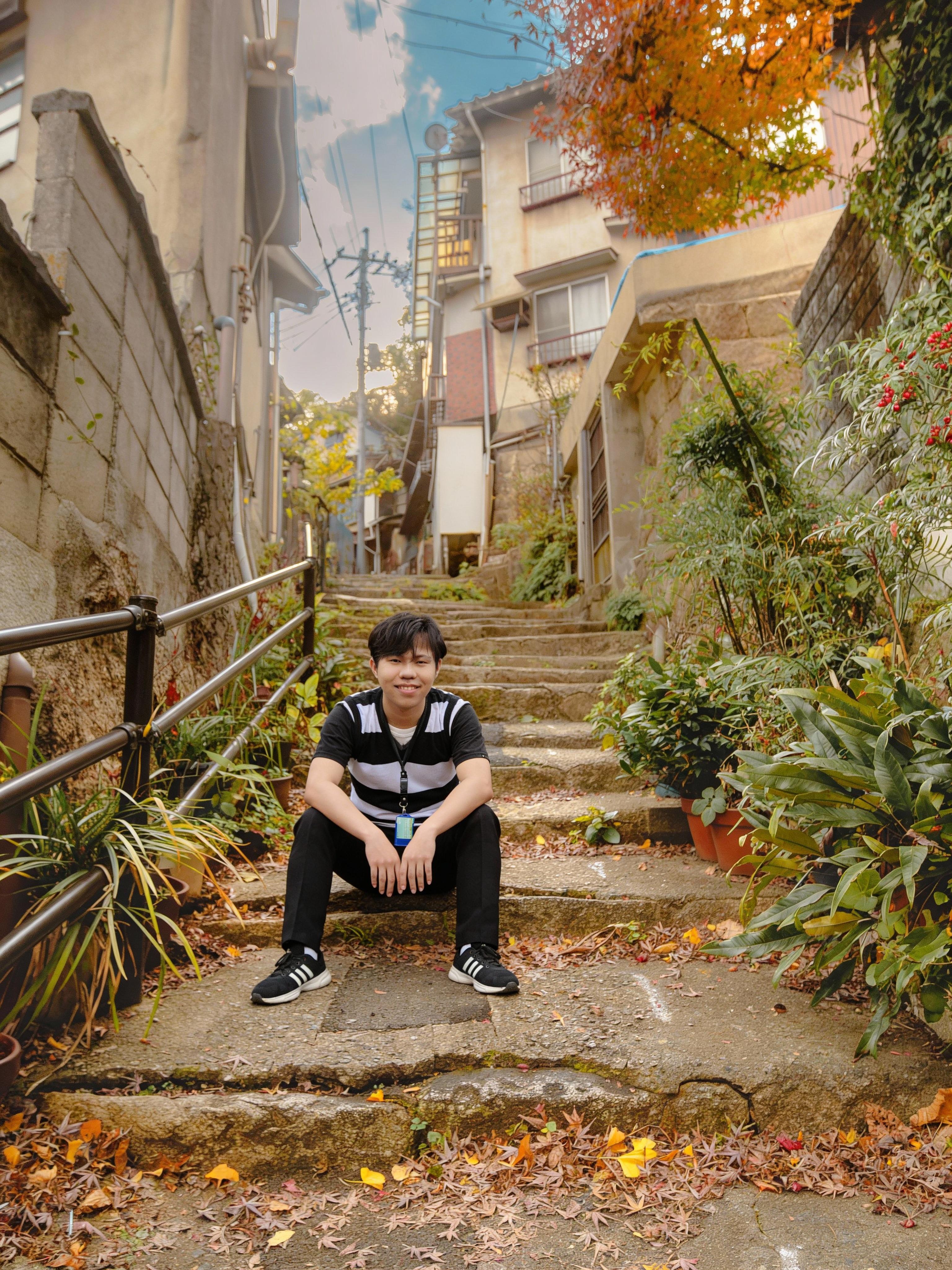 a-man-is-sitting-on-the-stairs-and-smiling-coolly-07rvtqbyaq