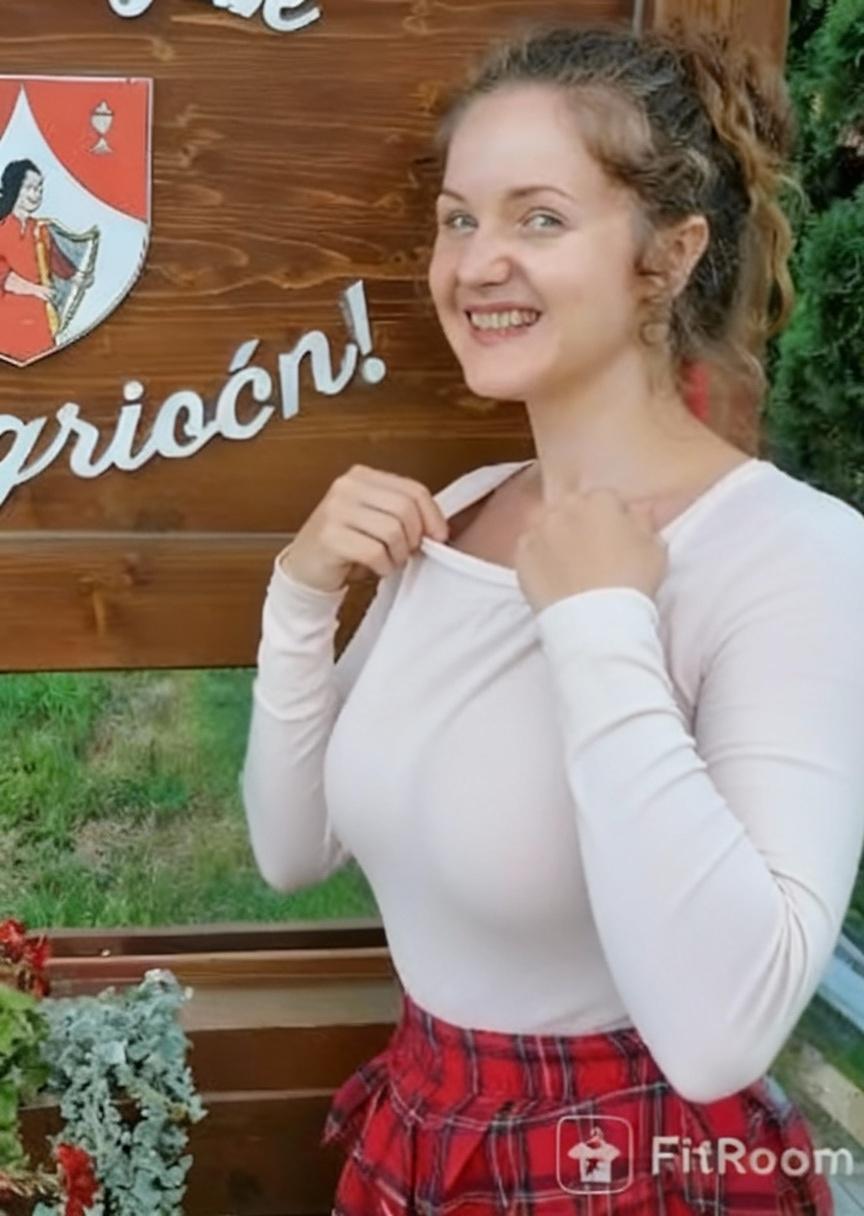 pulls-down-the-neckline-of-her-shirt-with-both-wez9clsp7v