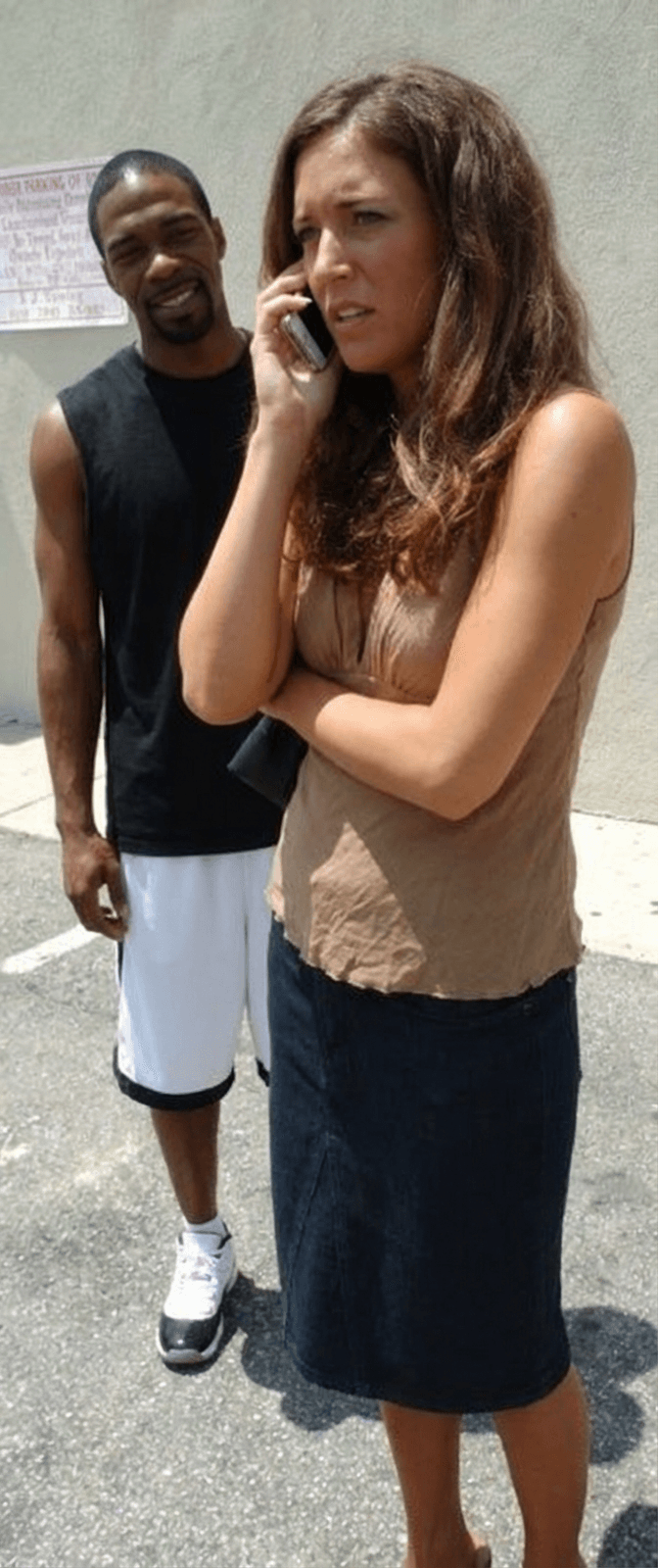 woman-talking-on-the-phone-while-a-black-man-njmq00y4uq